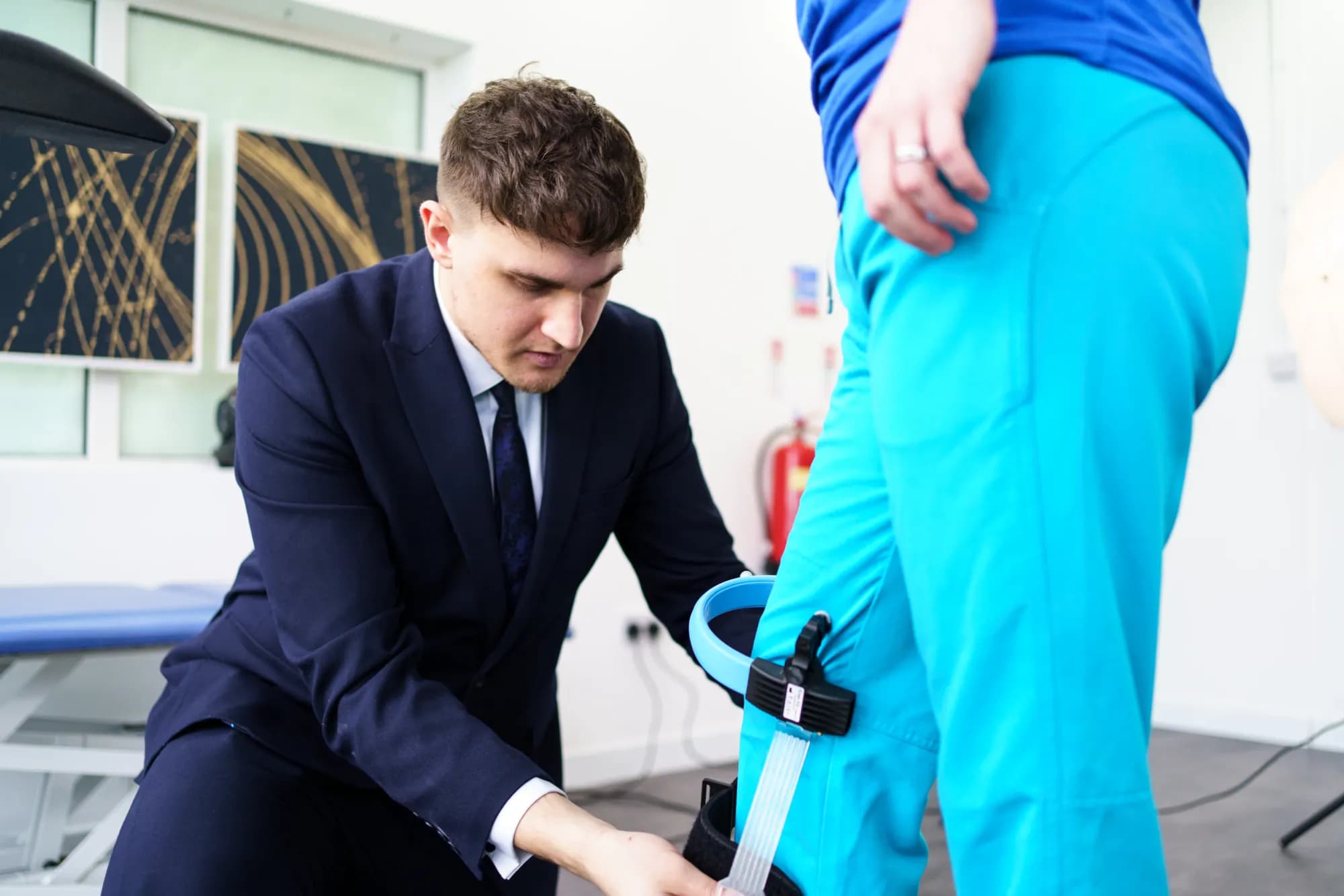A knee brace being fitted during rehabilitation